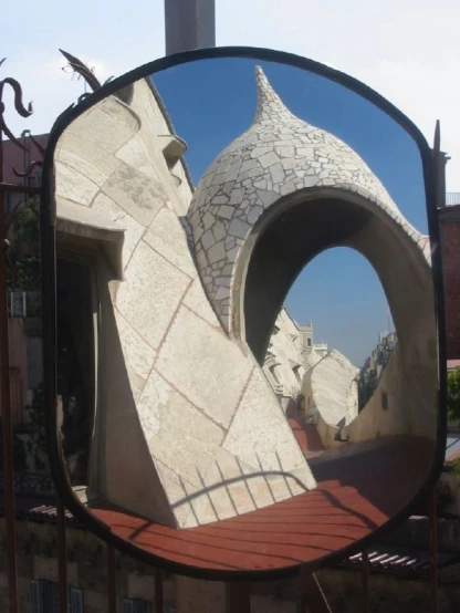 there is a large round mirror with statues