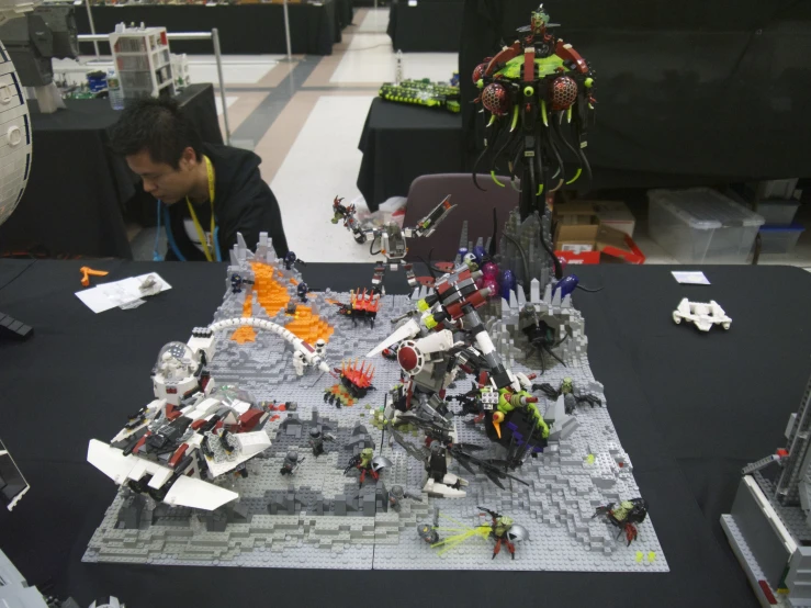 a display table with various toys and a man