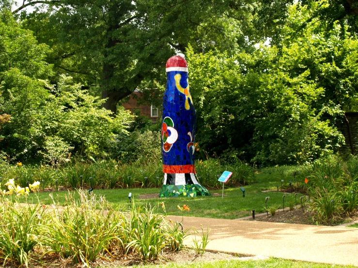 a large decorative wooden sculpture in the middle of a garden