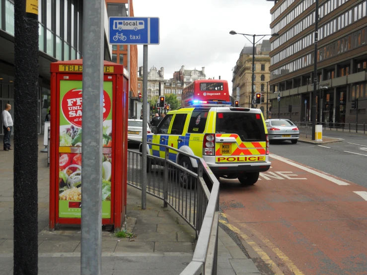 a police car parked at a curb near some buildings