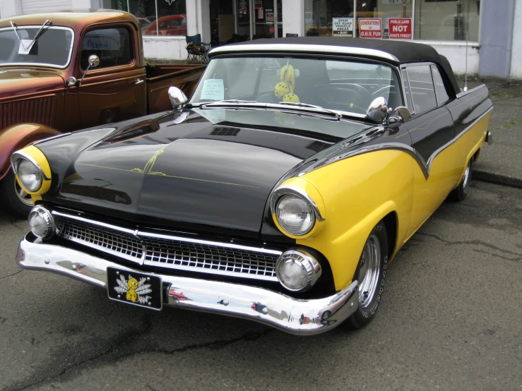 a black and yellow car with a lot of chrome around the windows