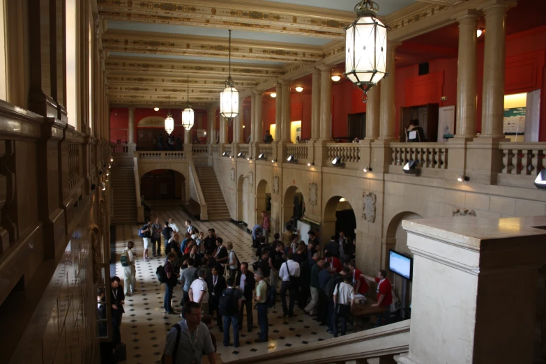 a group of people are standing in a big room