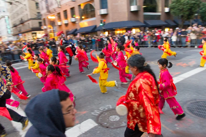 people are in a parade with colorful costumes