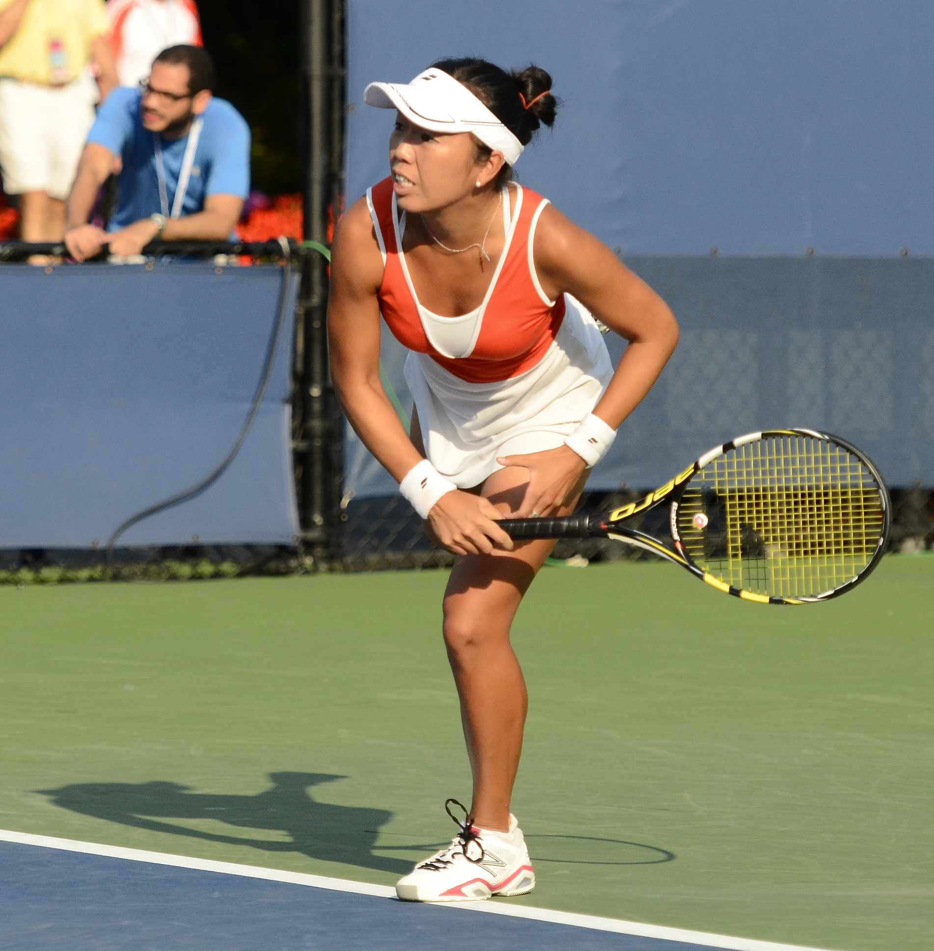 a woman standing on a tennis court holding a racquet