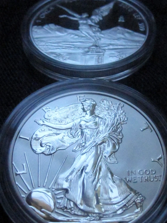 two silver coins that are on display
