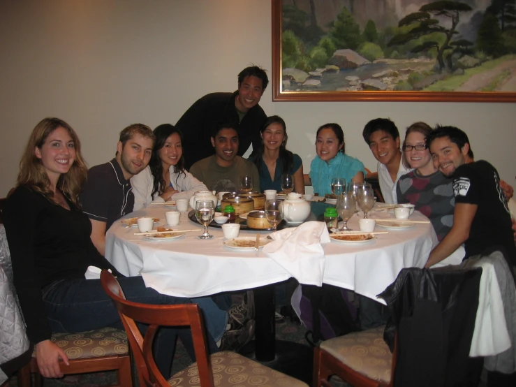 people are gathered around the table for a large meal