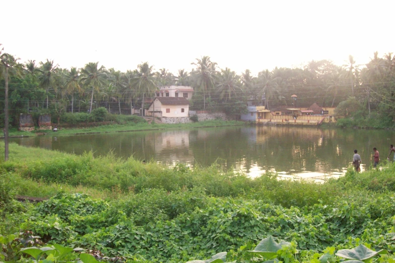 a lake that has people standing around it