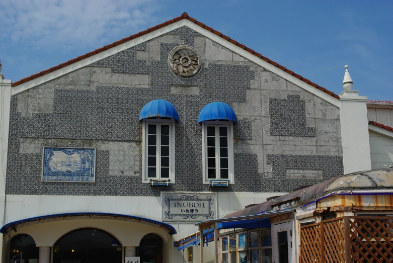 a building with a bunch of windows and a sign in front of it