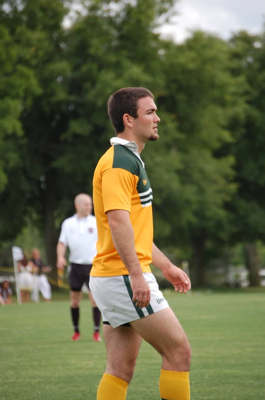 a man that is standing up wearing shorts