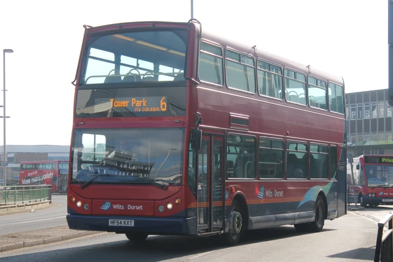 red and blue bus travelling on city street