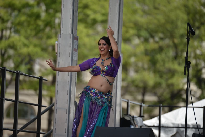 woman wearing a purple top and green skirt