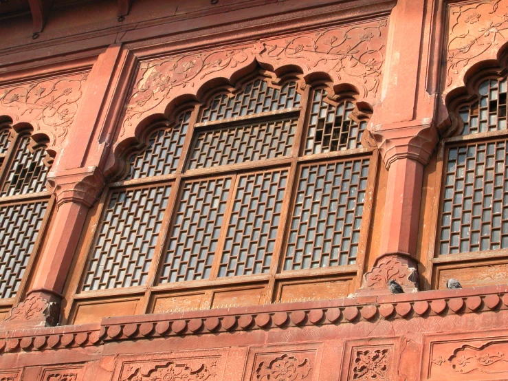 an intricately made window on the side of a building