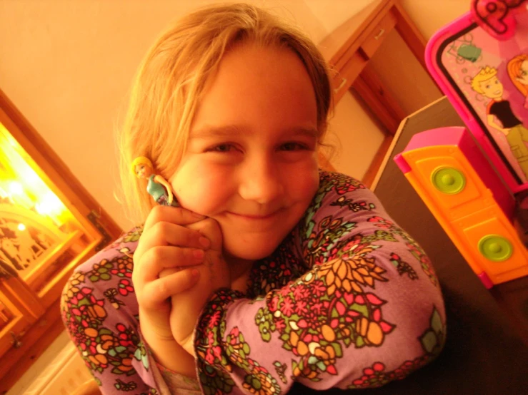 a child holding a cellphone to her mouth