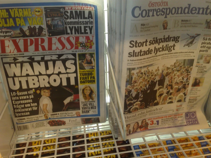 there are two newspapers displayed on the display rack