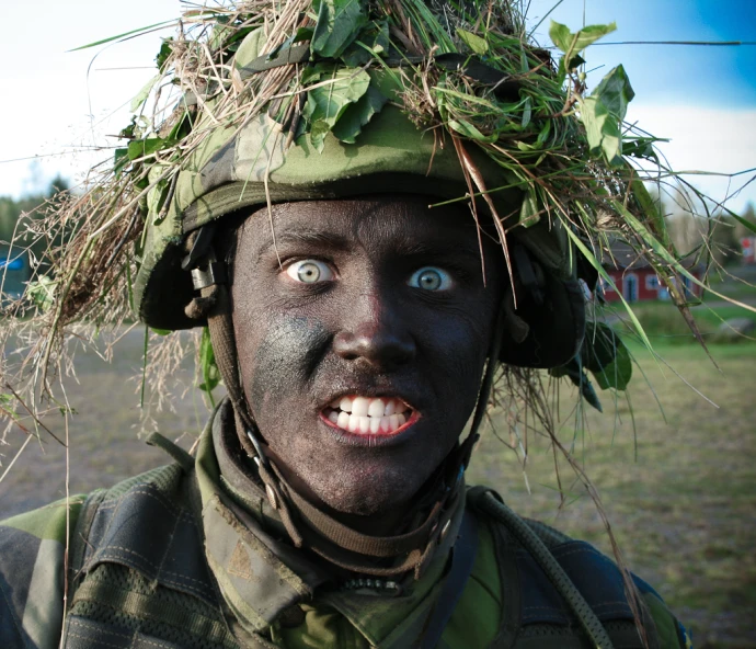 a guy with blue eyes wearing a soldier uniform