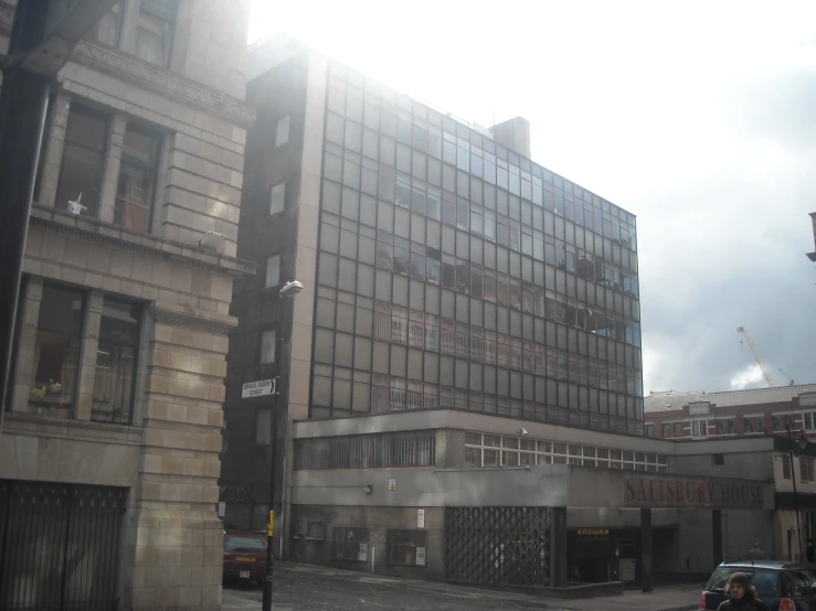 an empty street with a large building in the background