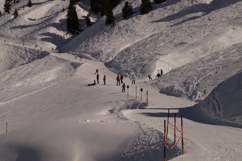 people skiing down a mountain covered with snow