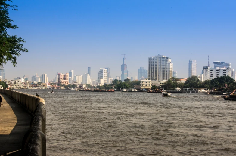 a river next to a city with boats on it