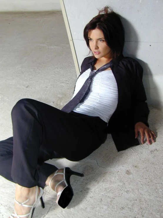 a woman with black hair posing on the cement