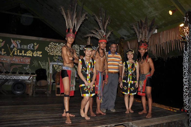 several men and children are standing in costumes