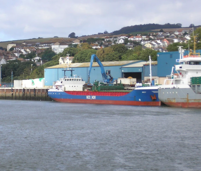 a ship is parked by the water's edge