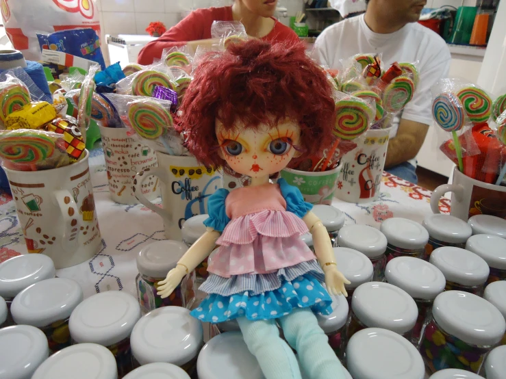 a little doll is in a room full of candy cans