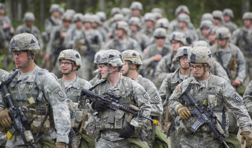 military men are marching down a street in formation