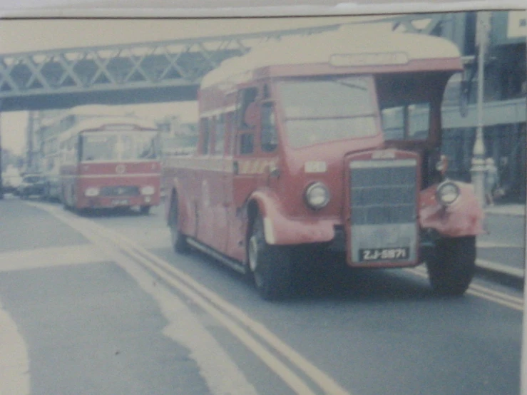 a po taken from a vehicle shows a group of buses on the road