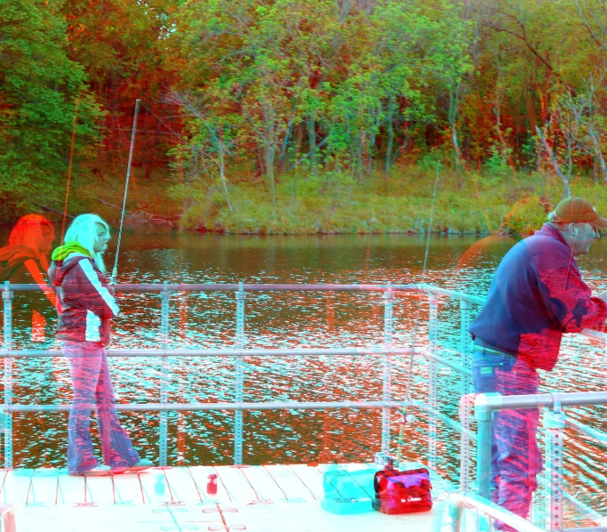 two men standing on a pier in front of water