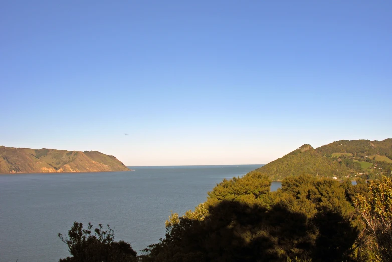 an area overlooking the water that is surrounded by wooded area