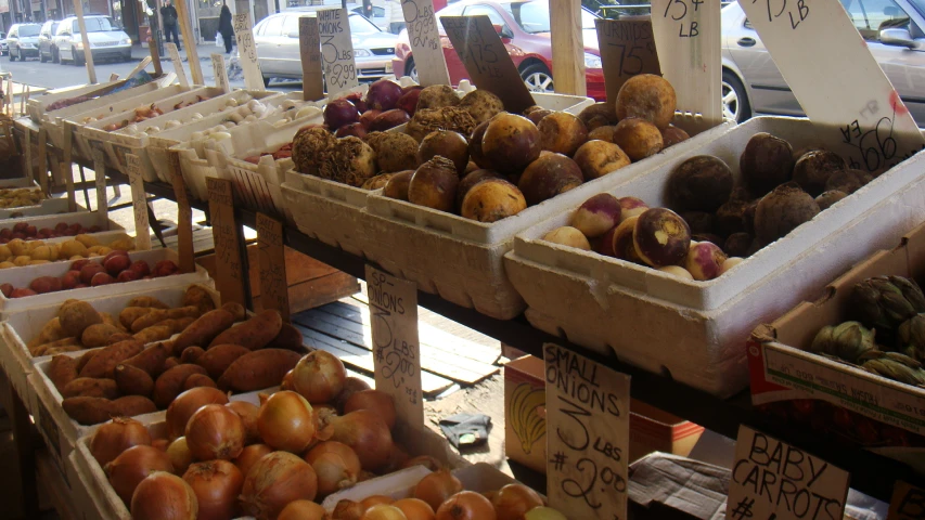 many boxes filled with fruit and vegetables on a market