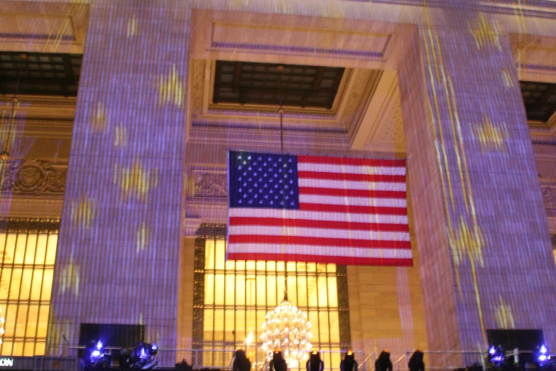 a flag hanging over a lobby with lights