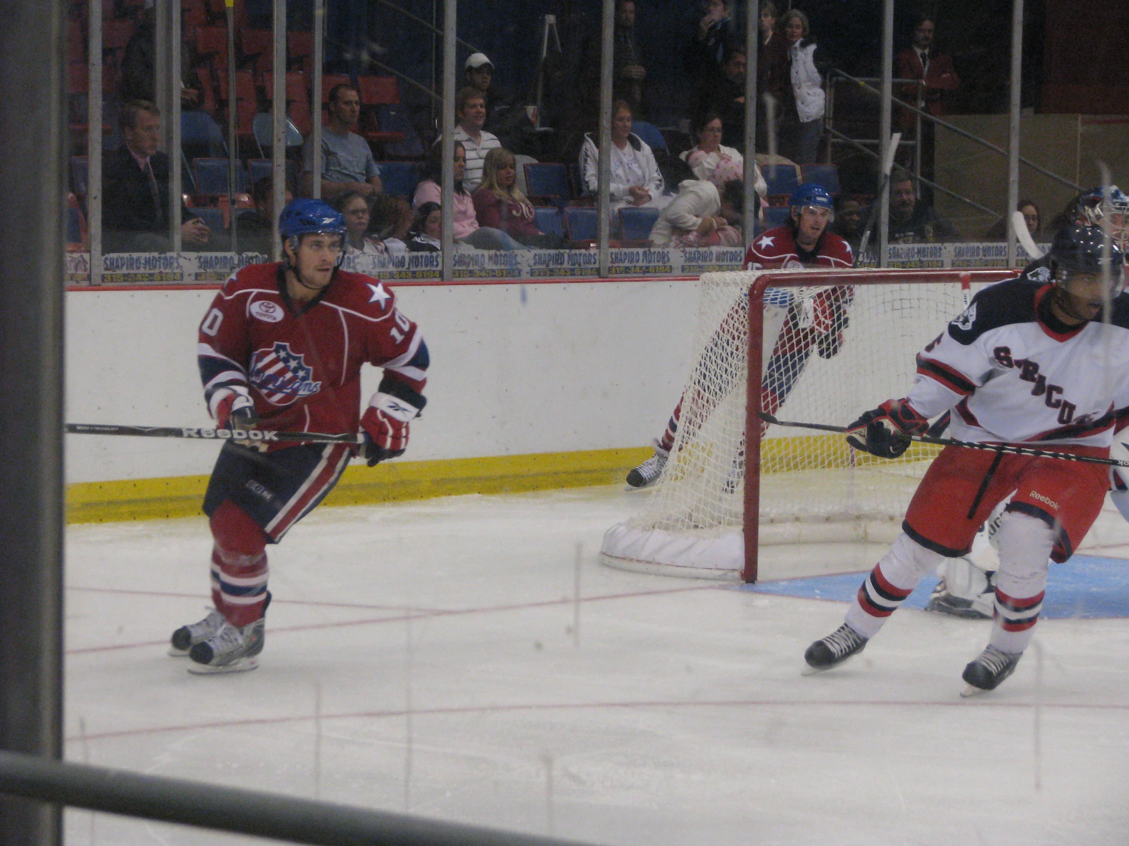 a hockey goalie and another player on the ice