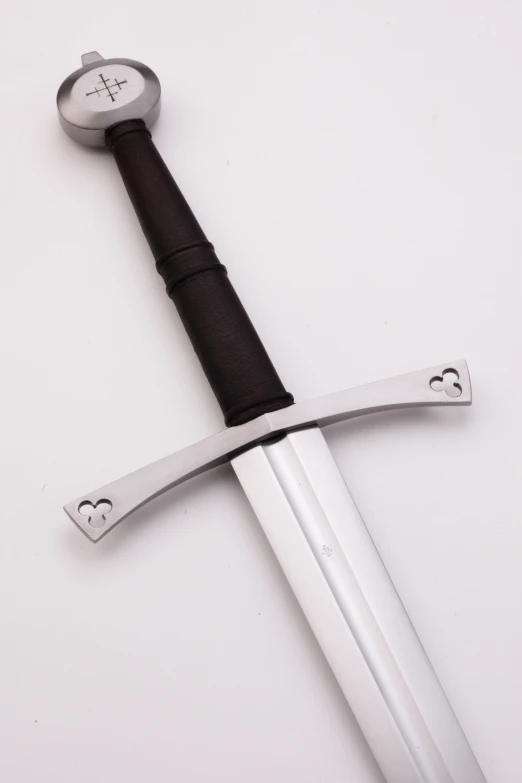 a sword with two crossed blades sitting on a white surface