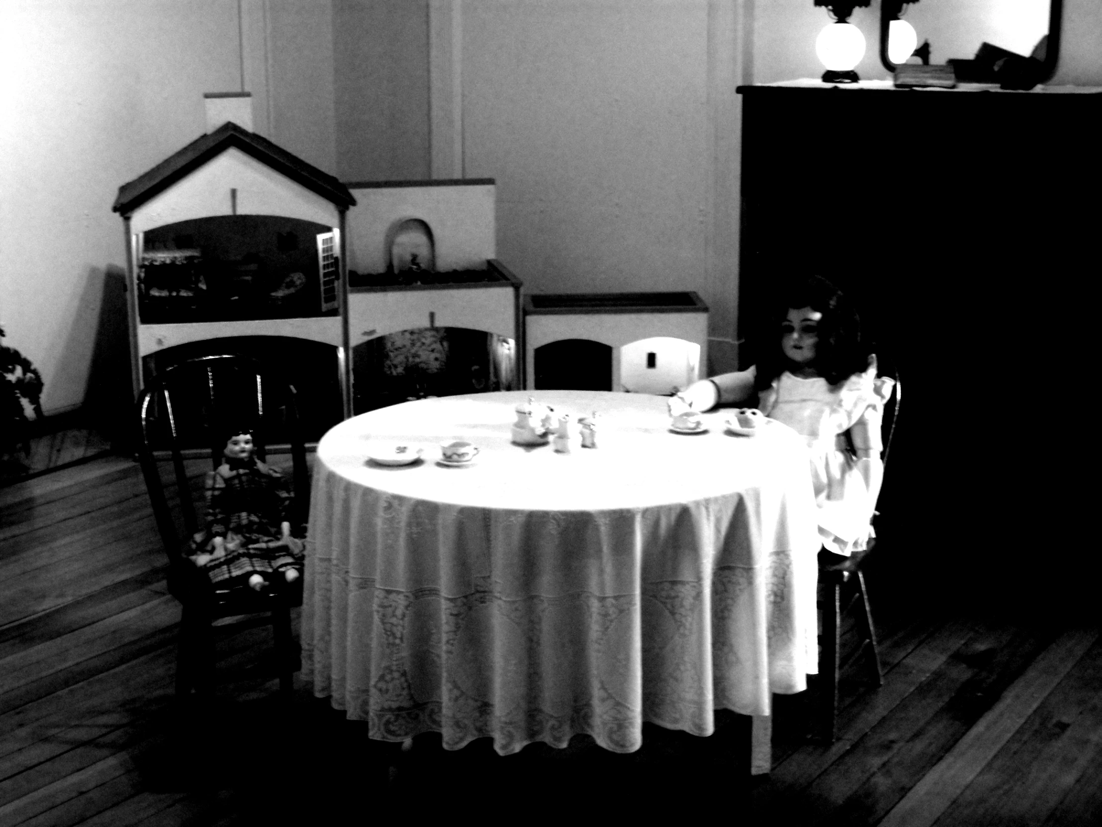 a  sitting at a dining table in front of a television