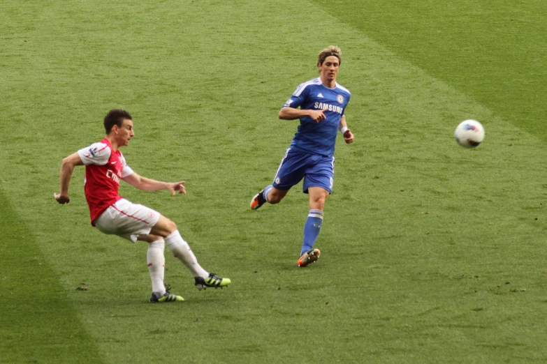 two players running for the soccer ball during a game