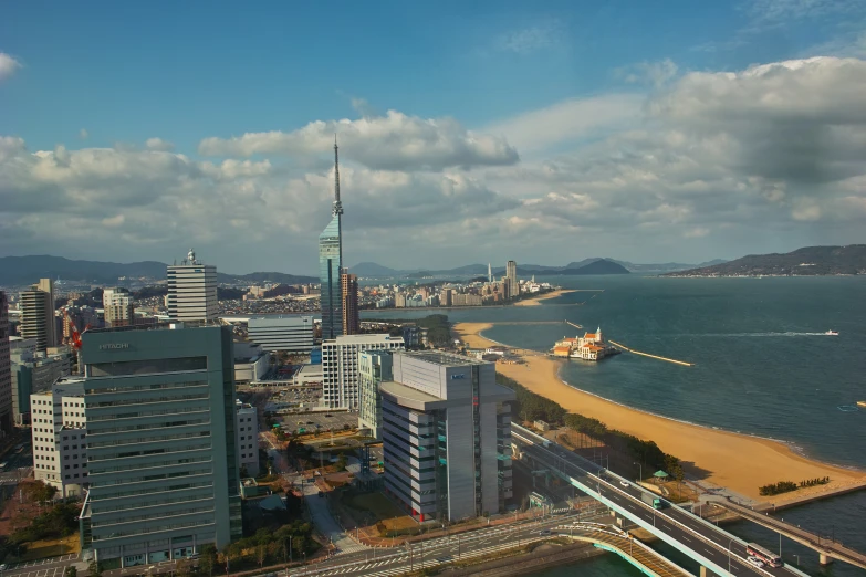 an aerial view of a city next to a big body of water