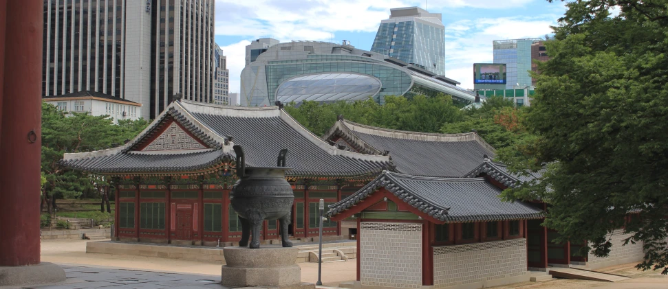 two buildings with roof tops surrounded by a park