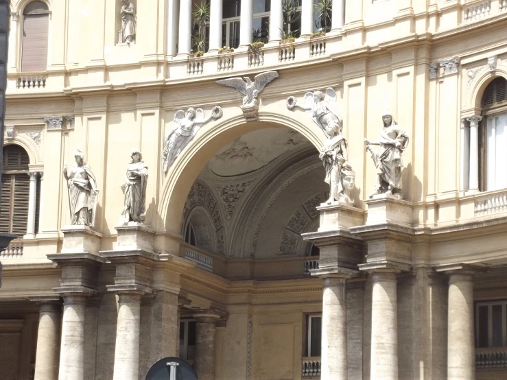 an old building with white statues on the entrance