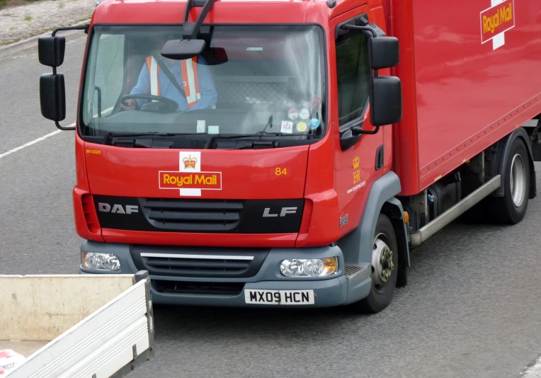 a truck that is red on the road