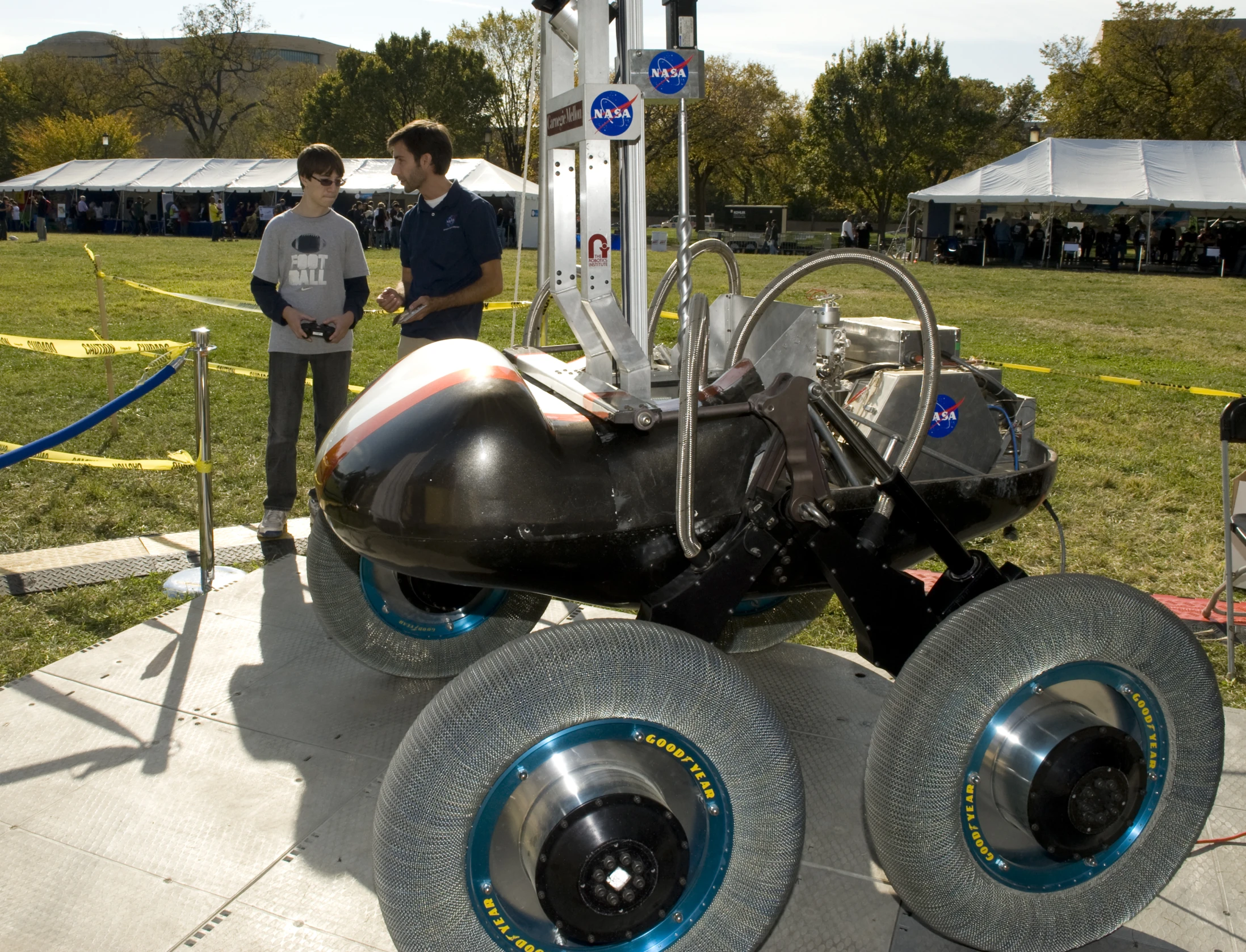 a black nasa vehicle with wheels on a display