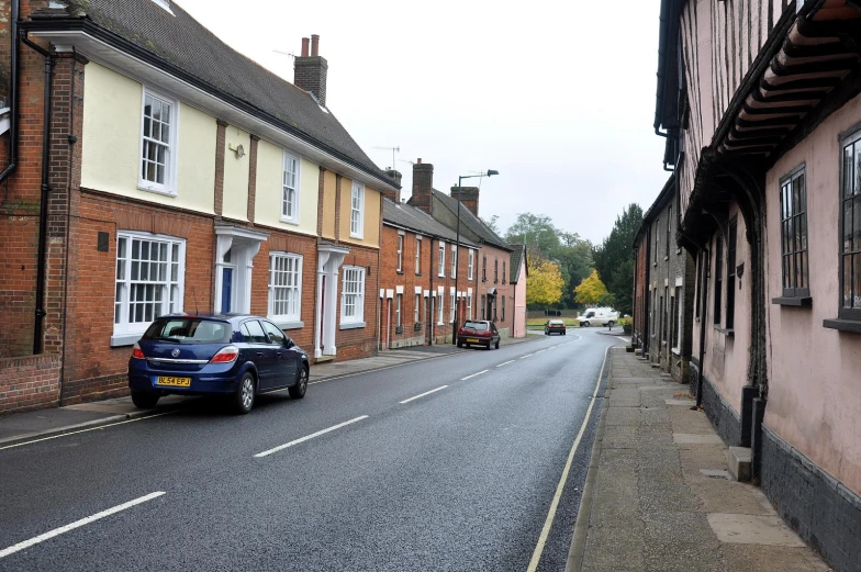 a narrow street in the countryside in autumn