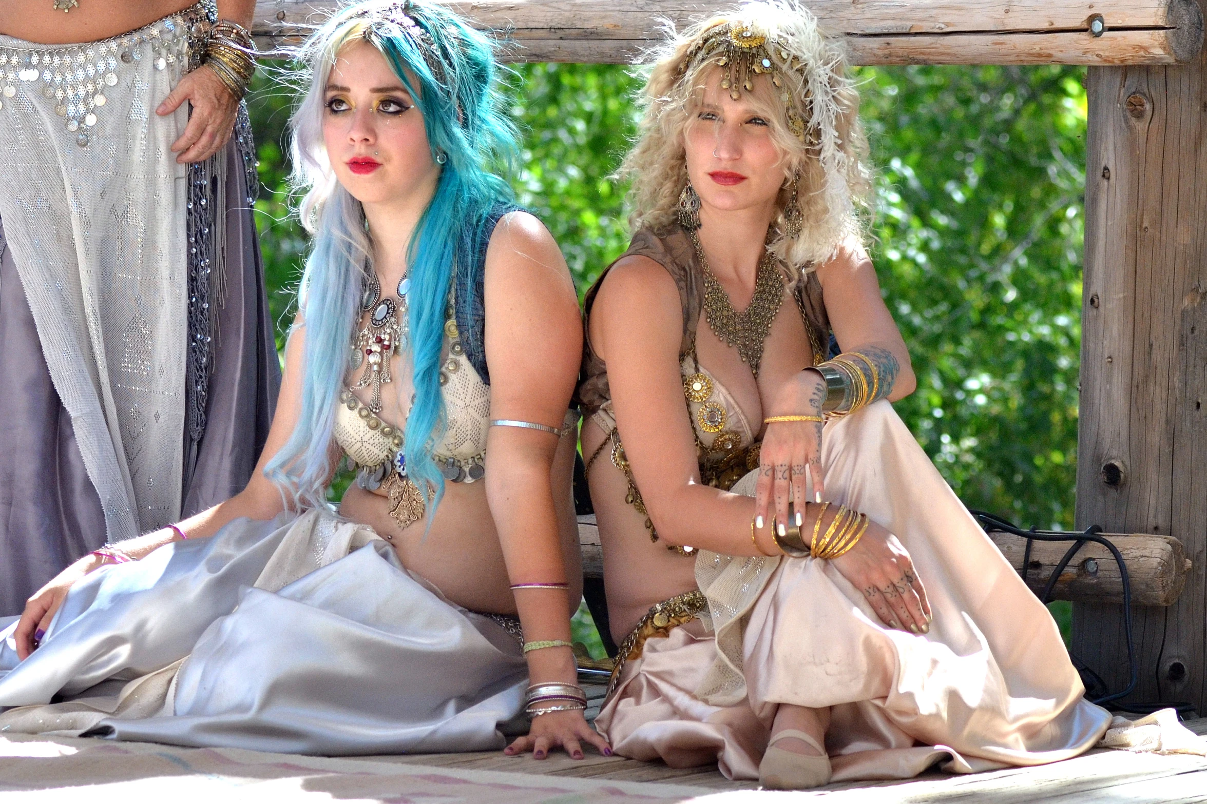 two women sitting next to each other on a blanket