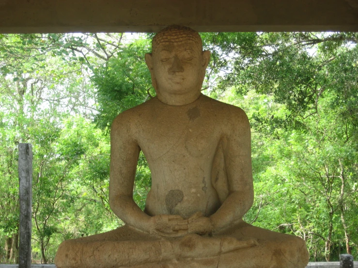 a very big statue sitting in a yoga position