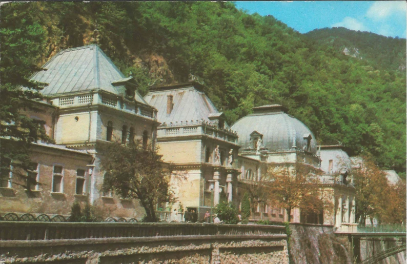 an old pograph of some buildings with a scenic view