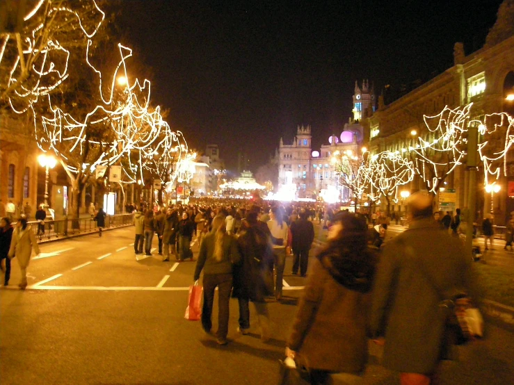 many people on a street are dressed up and walking