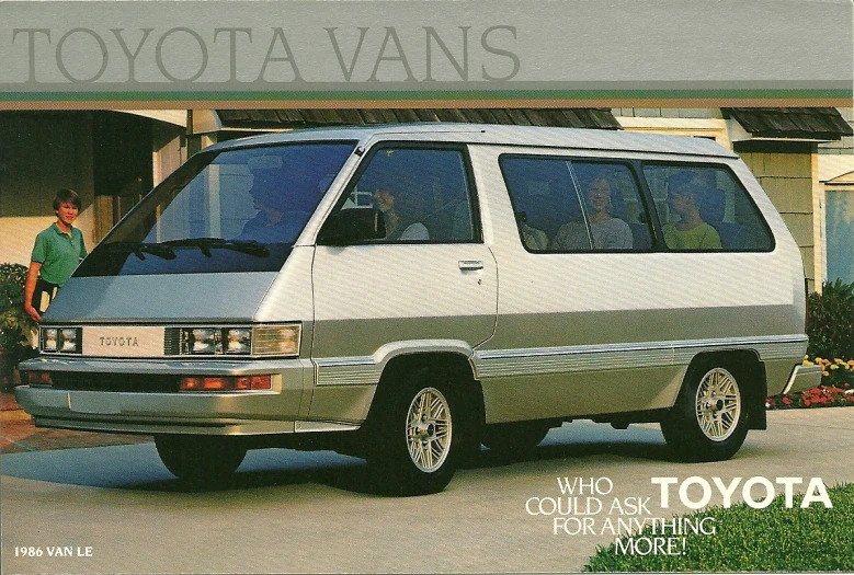 a silver toyota van parked in front of a house