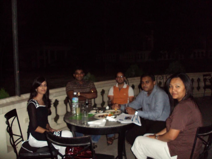 a group of people at a table in a city