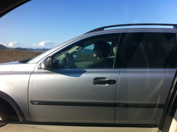 a man in the drivers seat sitting in a vehicle