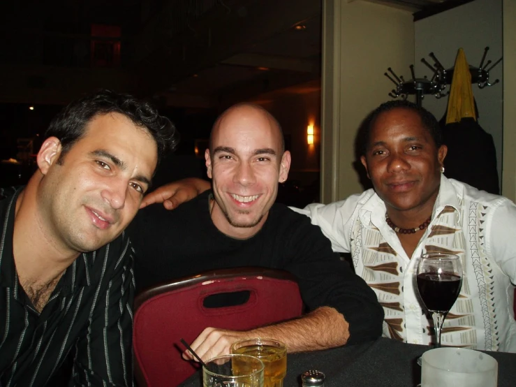 four people sitting at a table and smiling